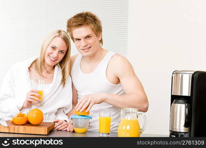 Breakfast happy young couple make orange juice in morning kitchen