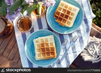breakfast in the garden - Belgian waffles and cup with tea
