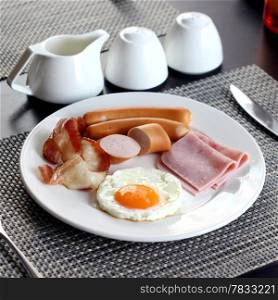 Breakfast meal with ham ausage bacon and egg