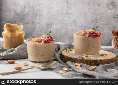 Breakfast oatmeal porridge with raspberries, almond, cinnamon, almond butter and coconut. Healthy breakfast delicious homemade english breakfast concept