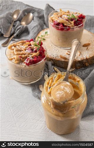 Breakfast oatmeal porridge with raspberries, almond, cinnamon, almond butter and coconut. Healthy breakfast delicious homemade english breakfast concept