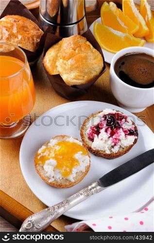 Breakfast of bun with ricotta orange and cherry jam