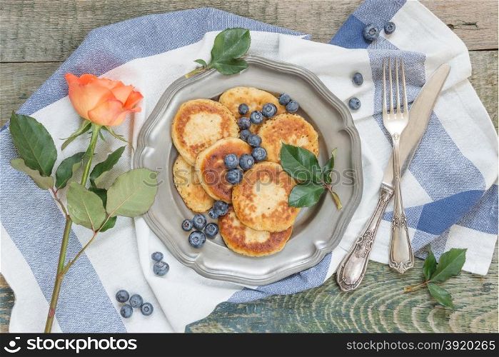 Breakfast of pancakes with ripe blueberry, top view