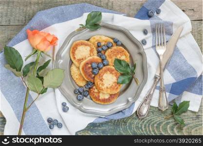 Breakfast of pancakes with ripe blueberry, top view