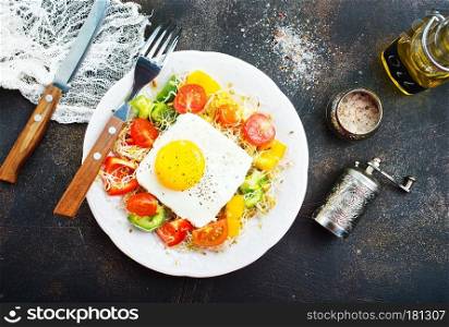 breakfast on a table, fried egg with salad