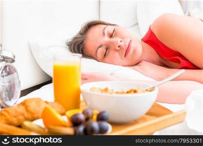 breakfast on a tray beside the bed sleeping girl