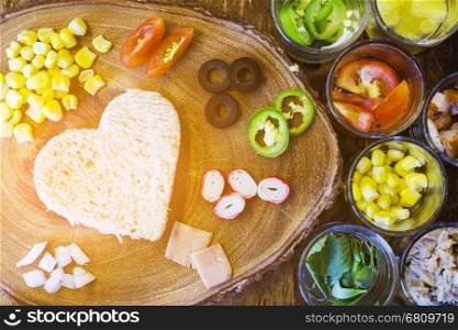 Breakfast on Valentine's day - heart-shaped bread with various ingredients for breakfast meal
