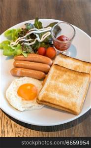 Breakfast sausage set with fried egg. Breakfast set
