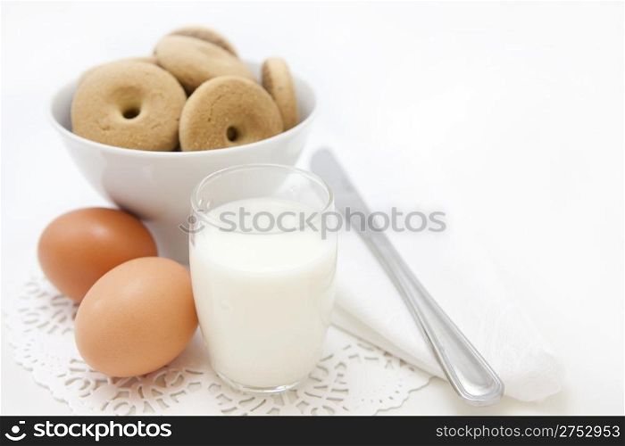 Breakfast set with fresh eggs, biscuits and milk