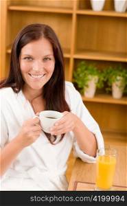 Breakfast - Smiling woman with cup of coffee in modern interior
