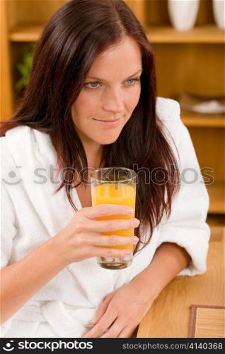 Breakfast - Smiling woman with fresh orange juice in modern interior