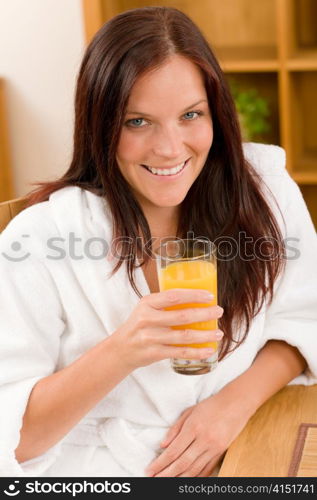 Breakfast - Smiling woman with fresh orange juice in modern interior