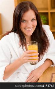 Breakfast - Smiling woman with fresh orange juice in modern interior