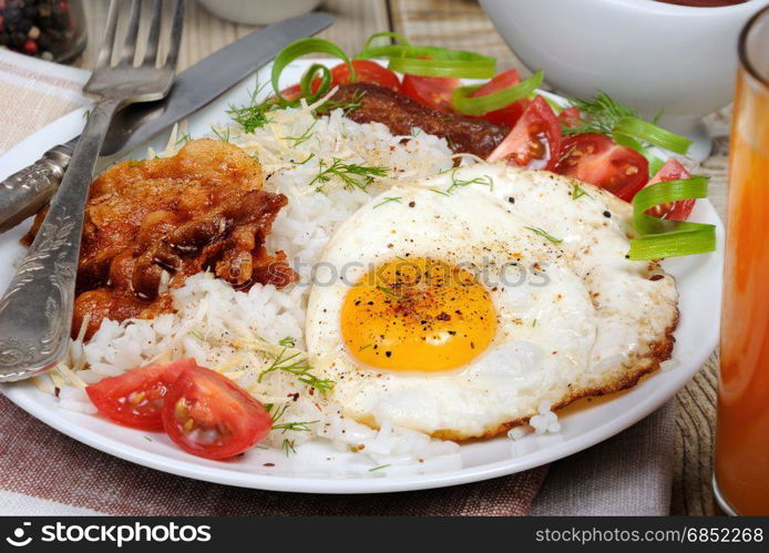 Breakfast - Soft boiled rice with scrambled eggs, bacon, tomato slices and greens