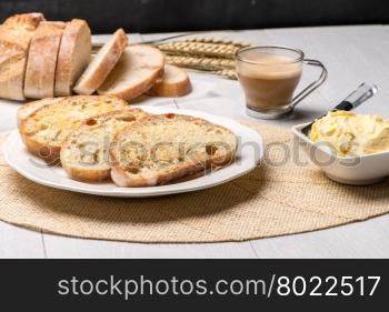 Breakfast table with bread toast with butter and milk with coffee.