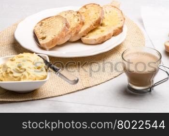 Breakfast table with bread toast with butter and milk with coffee.