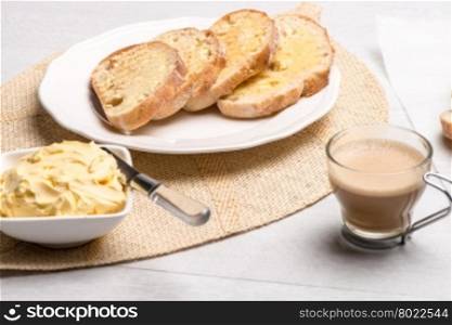 Breakfast table with bread toast with butter and milk with coffee.
