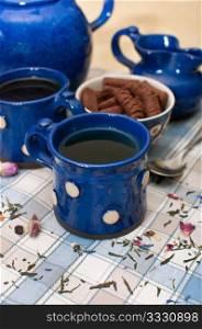 Breakfast - Tee and Coffee in Blue Mugs on the Table