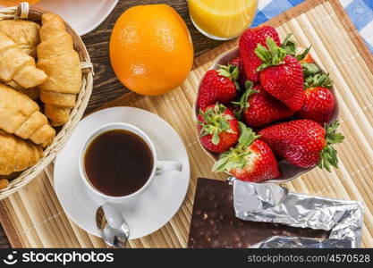 Breakfast with assortment of pastries, coffees and fresh strawberries