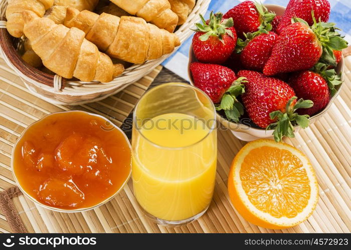 Breakfast with assortment of pastries, coffees and fresh strawberries