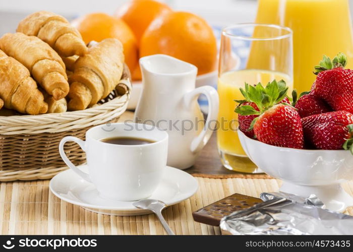 Breakfast with assortment of pastries, coffees and fresh strawberries