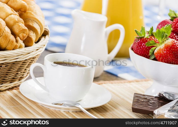 Breakfast with assortment of pastries, coffees and fresh strawberries