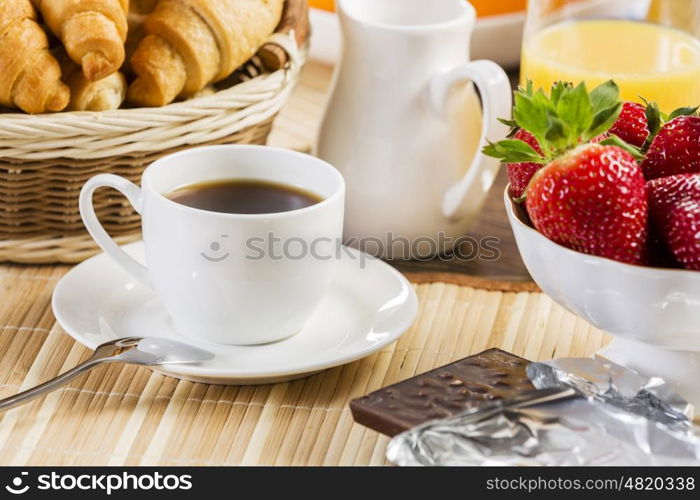 Breakfast with assortment of pastries, coffees and fresh strawberries