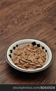 Breakfast with cereal in a bowl isolated against a wooden background