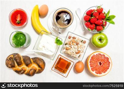 Breakfast with coffee, croissants, muesli, fresh berries, fruits. Healthy food concept. Top view