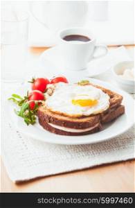 Breakfast with coffee, Croque Madame sandwich on a plate