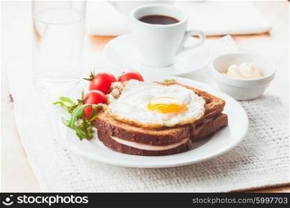 Breakfast with coffee, Croque Madame sandwich on a plate