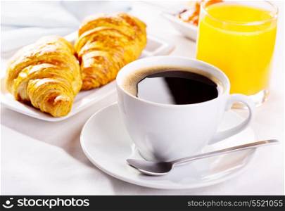 breakfast with cup of coffee, croissants and orange juice
