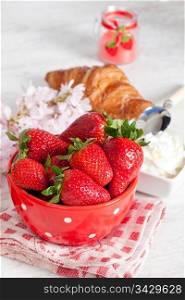 Breakfast with fresh strawberries and croissant