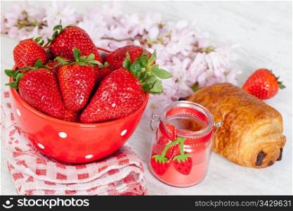 Breakfast with fresh strawberries and croissant