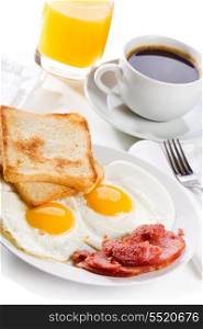 breakfast with fried eggs, toasts, juice and coffee