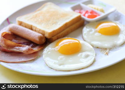 Breakfast with ham , fried egg and bread