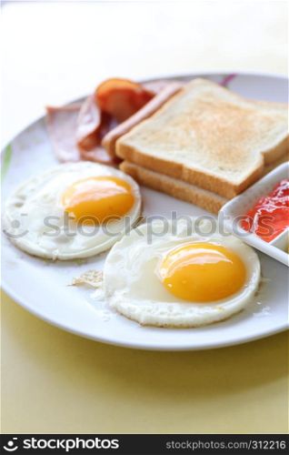 Breakfast with ham , fried egg and bread
