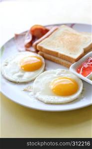Breakfast with ham , fried egg and bread