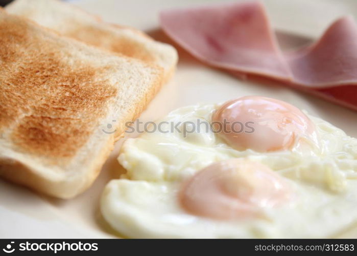 Breakfast with ham , fried egg and bread