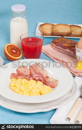 Breakfast with scrambled eggs and crispy bacon