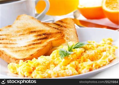 breakfast with scrambled eggs, toasts, juice and coffee