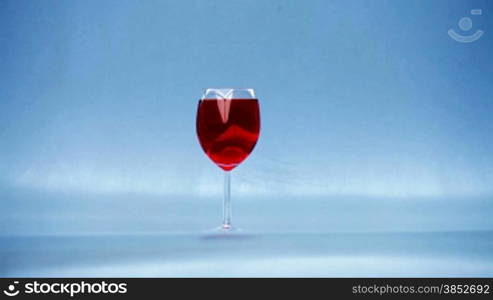 Breaking glass with wine, smash into