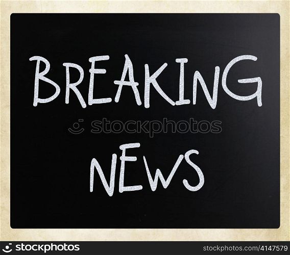 ""Breaking news" handwritten with white chalk on a blackboard"