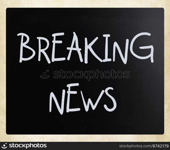 ""Breaking news" handwritten with white chalk on a blackboard"