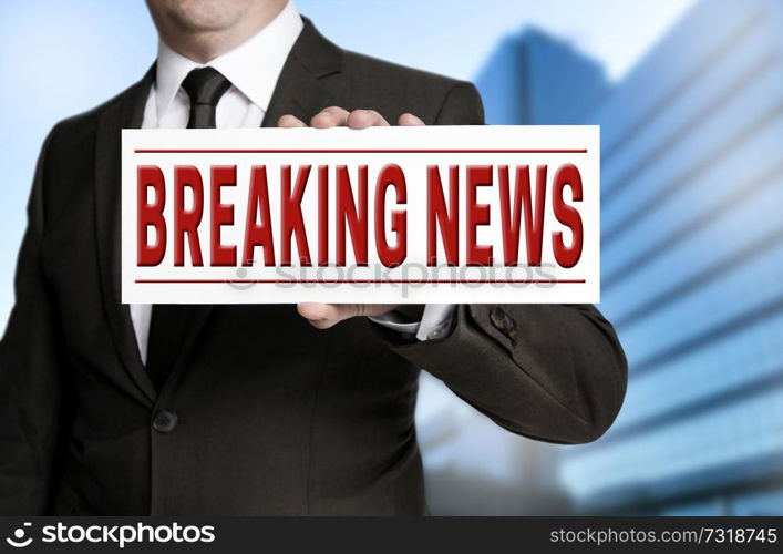 breaking news sign is held by businessman.. breaking news sign is held by businessman