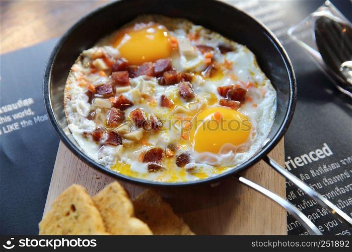 Brealfast fried egg stuff with hot pan with bread
