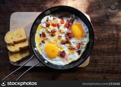 Brealfast fried egg stuff with hot pan with bread