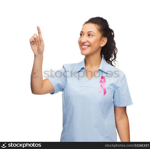breast cancer awareness, healthcare and technology concept - african american doctor or nurse pointing to something or pressing imaginary button
