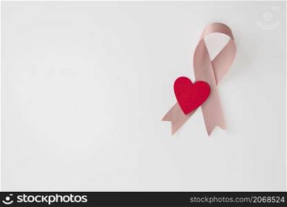 Breast Cancer Awareness Pink Ribbon en red heart . World Breast Cancer Day concept . Women healthcare concept isolated on white background copy space. Breast Cancer Awareness Pink Ribbon en red heart . World Breast Cancer Day concept . Women healthcare concept isolated on white background