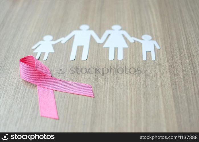Breast Cancer Awareness, Pink Ribbon with family paper shape for supporting people living and illness. Woman Healthcare and World cancer day concept
